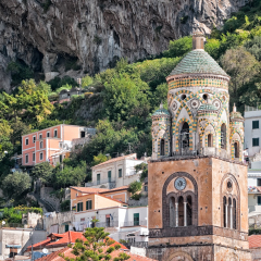 Close up of bell tower, Amalfi Cathedral, (Cattedrale di Sant'Andrea/Duomo di Amalfi), dating back to 9th century. Roof is covered with typical green majolica tiles common in Southern Italy.