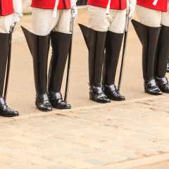 Royal horse guards at the Admiralty House in England. Part of body, solider boots