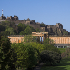 Scenic view of Edinburgh Castle and the National Gallery with Princes Street Gardens in the foreground.