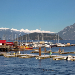 Horseshoe Bay West Vancouver Marina, parking of boats and yachts on the background of snow-covered mountains ridge