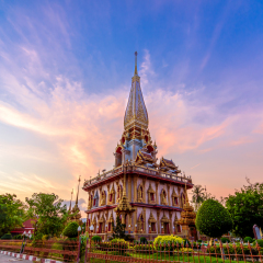 Pagoda in wat chalong or chalong temple with twilight background after sunset, public place.