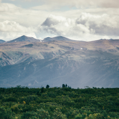 Beautiful landscape of Edziza provincial park in British Columbia Canada. Mountains in the distance. Clouds in the sky. 