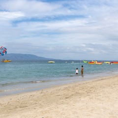 Seascape of beach with transparent sea, blue sky and boats.Taken at Sabang, Puerto Galera, Mindoro island, Philippines, popular tourist and diving spot. Reminds of heaven or travel of dream.