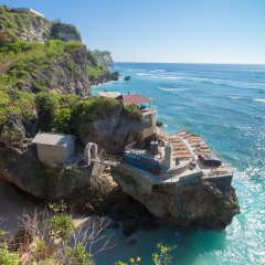 Ulu Watu coastline with beaautiful rocky cliffs and turquoise wavey sea.