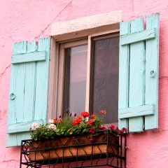 Pink wall of a house with blue window in La Provence Village. Colorful sights in  French style, South Korea.