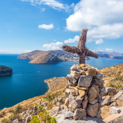 Cross on a hill with Lake Titicaca in the background taken from Isla del Sol in Bolivia