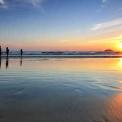 Silhouettes of people in Tanjung Aru Beach, Kota Kinabalu, Sabah Borneo, Malaysia.