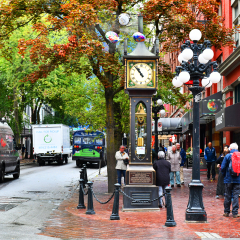 Vancouver BC, Canada - September 25, 2017 :Tourists gather around Steam Clock sound the hour in Vancouver's historic Gastown district