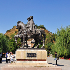 HOHHOT, CHINA - OCTOBER 10, 2012: Tourists at the The bronze statues of Wang Zhaojun and Huhanye in Zhaojun Tomb. Zhaojun Tomb is one of the tourist attraction in Inner Mongolia, China.