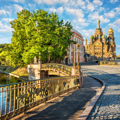 The Cathedral of the Savior on Blood in St. Petersburg and the openwork fence of the bridge across the Moika on an early sunny summer morning