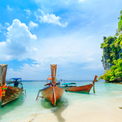 Longtale boat on the white beach at Phuket, Thailand. Phuket is a popular destination famous for its beaches.