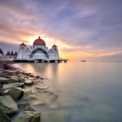 Majestic view of Malacca Straits Mosque ( Masjid Selat Melaka) with beautiful sunset background. It is a mosque located on the man-made Malacca Island near Malacca Town, Malaysia  