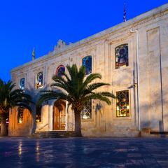 The Church of St Titus, or Agios Titos, in centre of Heraklion, Crete, at night with an almost full moon above it.