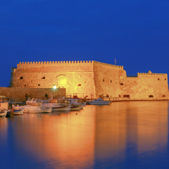 View of the medieval Venetian Castle and Heraklion port at sunset. Crete. Greece.