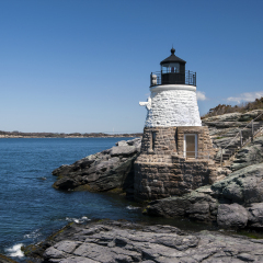 Castle Hill lighthouse is constructed on rocky ledges and small cliffs to guide mariners into Narragansett Bay in Newport, Rhode Island.