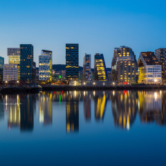 Modern buildings in Oslo at twilight with their reflection into the water. These are some of the new buildings in the neighbourhood of Bjorvika.