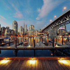 Vancouver False Creek at night with bridge and boat.