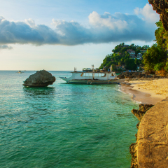 Landscape: cliffs and the sea with boats. Boracay island. Philippines.