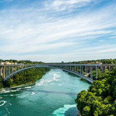 Rainbow Bridge, an arch bridge across the Niagara River gorge, and is a world-famous tourist site. It connects the cities of Niagara Falls, New York (to the east), and Niagara Falls, Ontario (west).