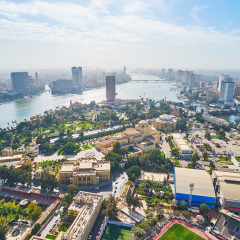 Aerial view of Gezira Island with Opera House and museums and the banks of Nile river with dense housing of Cairo and Giza, Egypt.