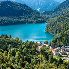 Alpsee - Alpine lake and the Hohenschwangau Village, Schwangau, Ostallgau district, Bavaria, Germany. It is located near the Neuschwanstein Castle and the Hohenschwangau Castle 