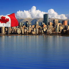Canadian flag in front of the beautiful city of Vancouver, Canada.