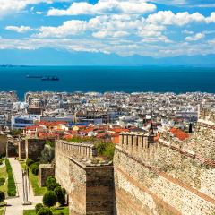THESSALONIKI, GREECE - APRIL 8, 2017: Panoramic View of Thessaloniki and its Byzantine Wall Ruins, along with Thermaikos Gulf and Mount Olympus in the Background as seen from the Old Town. 