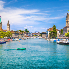 Panoramic view of historic Zurich city center with famous Fraumunster, Grossmunster and St. Peter and river Limmat at Lake Zurich on a sunny day with clouds in summer, Canton of Zurich, Switzerland