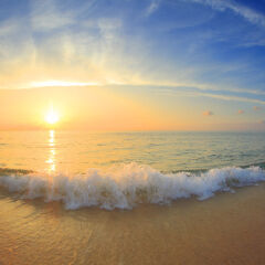 Sunset over ocean and sandy beach
