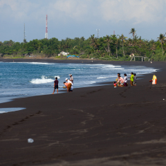 BALI, INDONESIA - SEP 26: Balinese Hindu devotees give offerings for the spirits of the the sea an a beach for the ritual near Goa Lawah Bat Cave temple on Sep 26, 2012 in Bali, Indonesia.