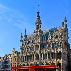 BRUSSELS, BELGIUM - JUNE 30, 2010: The Grand Place is famous for its stone, bronze and golden decorations, fretwork, sculptures on the Breadhouse, Town Hall and guildhalls, on June 30 in Brussels.