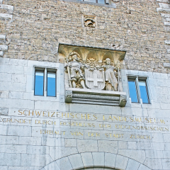 ZURICH, SWITZERLAND - MARCH 20, 2011: The stone sculptural group decorates the gate tower of Swiss National Museum, on March 20 in Zurich.