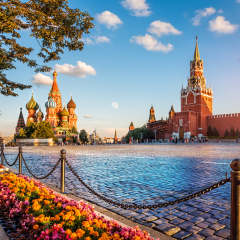 St. Basil's Cathedral and Spassky Tower on Red Square in Moscow on a summer evening and colorful flowers