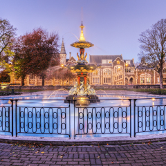 The restored Peacock Fountain in Christchurch Botanic Gardens at twilight with the Arts Centre (former University) in the background.
