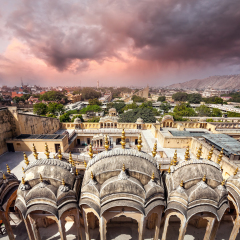 View to Old Jaipur city sight from the roof of Hawa Mahal Palace at purple overcast cloudy sky in Rajasthan, India