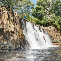 SOUILLAC, MAURITIUS - NOVEMBER 29, 2015: Rochester Waterfalls In Mauritius Island. Man jumps into the water.