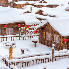 Snow covered wooden cabin with thick snow on the roof