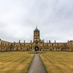 OXFORD, UK - MAY 19, 2015: Tom Tower and Tom Quad. It is an elegant 17th-century bell tower over the Tom Gate, the main entrance to Christ Church College, the University of Oxford, England.