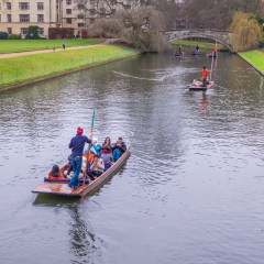 Oxford, UK - December 21, 2016 :  Unidentified people in a boat over the river  Cherwell near university of Oxford botanic gardens , Oxford, United Kingdom.