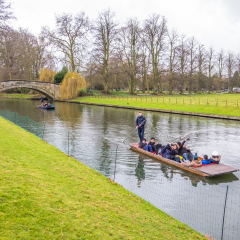 Oxford, UK - December 21, 2016 :  Unidentified people in a boat over the river  Cherwell near university of Oxford botanic gardens , Oxford, United Kingdom.
