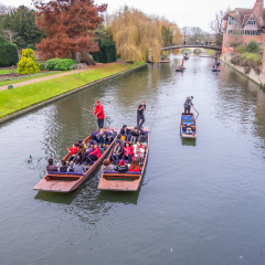 Oxford, UK - December 21, 2016 :  Unidentified people in a boat over the river  Cherwell near university of Oxford botanic gardens , Oxford, United Kingdom.