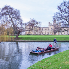 Oxford, UK - December 21, 2016 :  Unidentified people in a boat over the river  Cherwell near university of Oxford botanic gardens , Oxford, United Kingdom.