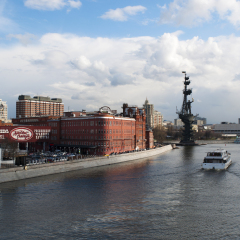 Moscow, 26/04/2017: one of the many cruises on the Moskva River and view of Peter the Great Statue, a 98-metre monument made in 1997 by Zurab Tsereteli to commemorate the 300 years of the Russian Navy