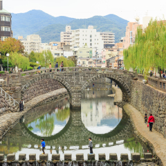 NAGASAKI - DEC,4:The nice view of the Meganebashi Bridge or Spectacle Bridge that was built in 1634.It's the oldest stone arch bridge in Japan. There are many tourists visiting here.JAPAN DEC,4 2016
