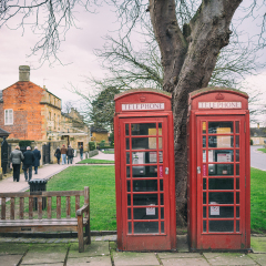 BROADWAY, UK - MARCH 6 2016: Small village urban scene - houses, urban green, sidewalks, lanes, telephone box (booth)