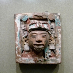 Mexico City, Mexico - January 2013: Sculpture of the face of Xipe Totec, god of earth and spring, Aztec civilization, at the National Museum of Anthropology.