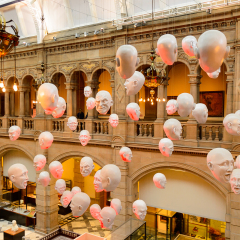 GLASGOW, SCOTLAND - JULY 16, 2016: Hanging heads in the East Hall of the Kelvingrove Art Gallery and Museum, Argyle Street, Glasgow. It's a popular attraction for the tourists
