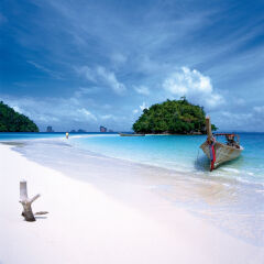 Long-Tailed Boat on White Sand Beach in Thailand.