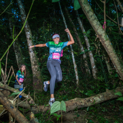 Khao Phra Thaeo National Park,Talang,Phuket,Thailand-September 3,2017. Thanyapura King Of The Mountain Run. a lady jumps across the death tree for racing in Khao Phra Thaeo national park.