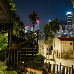 Singapore, Singapore - April 28, 2017: Spiral staircase climbing up to a downtown landscape view. Taken from Ann Siang Hill Park